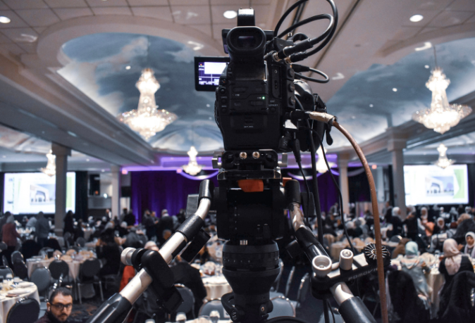 Professional videographer capturing live event moments with high-quality equipment