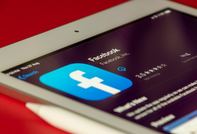 Rwandan business owner using Facebook and Instagram for marketing with engaging visuals, targeted ads, and local content.